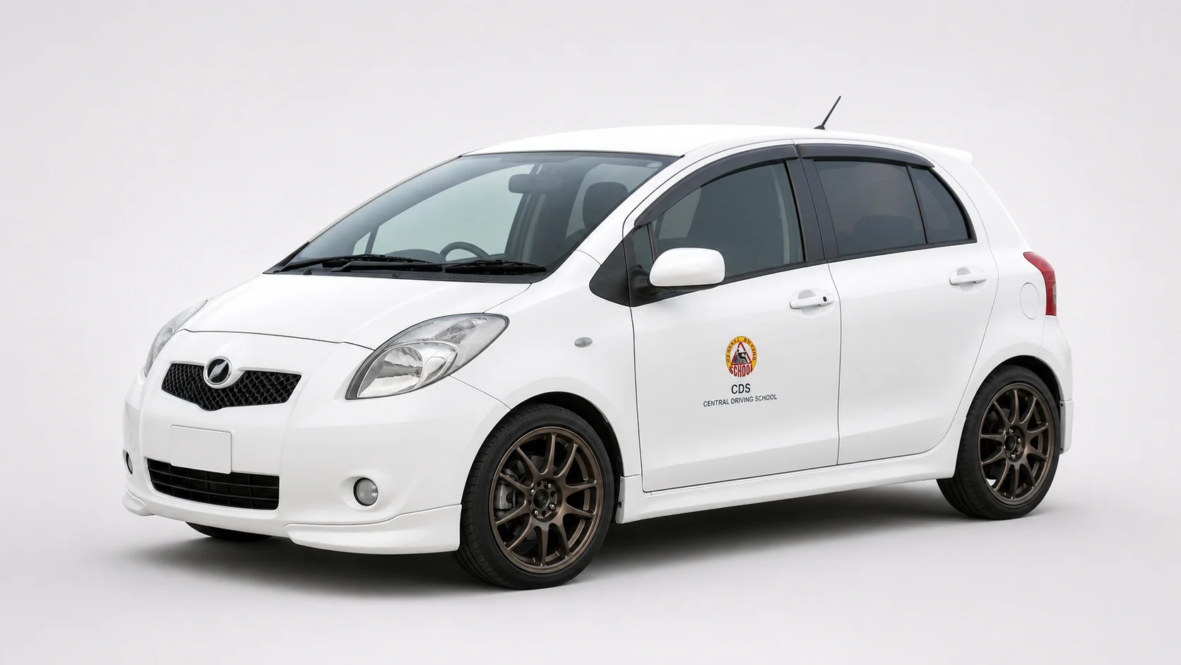 White Toyota Vitz with subtle CDS door branding for Class B practical training